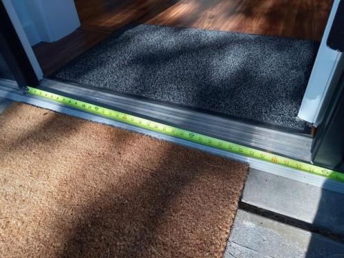 a glass door with a yellow measuring tape on it at Zen Haus Garden Retreat, prime location, Luxe amenities in Eugene