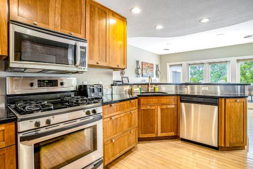 a kitchen with stainless steel appliances and wooden cabinets at Lake View Getaway in Saugatuck