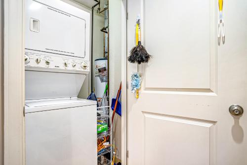 a closet with a white door and a refrigerator at Lake View Getaway in Saugatuck