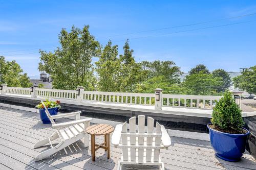 two white chairs and a table on a deck at Lake View Getaway in Saugatuck