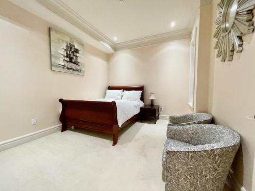 a bedroom with a bed and a chair at Vancouver Airport guesthouse in Vancouver