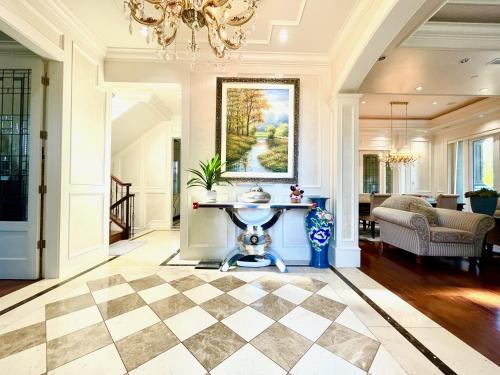 a living room with a checkered floor and a chandelier at Vancouver Airport guesthouse in Vancouver