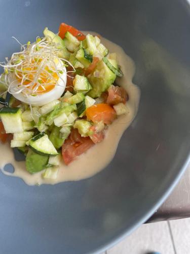 a salad with an egg and vegetables on a plate at Ar-Gavotenn in Le Saint