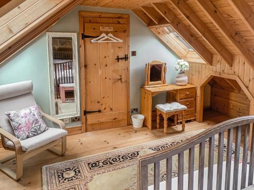a room with a staircase and a chair in a cabin at Seaton Cottage - Uk31990 in Staithes