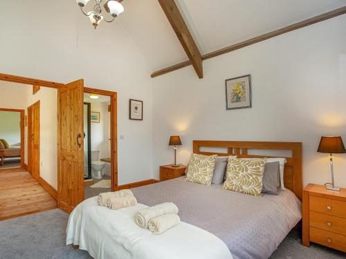 a bedroom with two beds with towels on them at Pondmead in Monk Okehampton