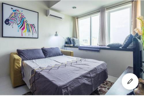a bedroom with a bed with a painting of a zebra at Fantastic Affordable high end condominium heart of the Cebu city in Cebu City
