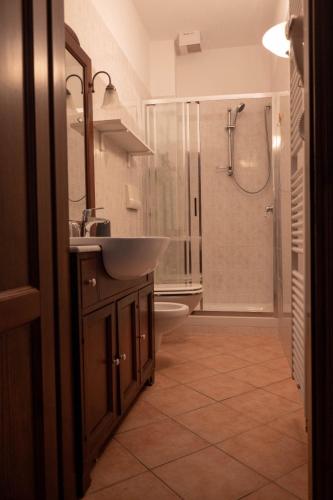 a bathroom with a sink and a shower at Affittacamere la Torre in Marzabotto