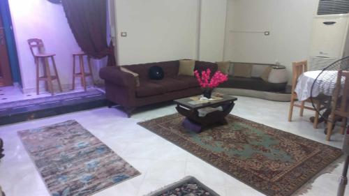 a living room with a couch and a table at Tanta طنطا Families Only in Tanta