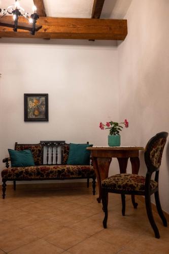 a living room with a couch and a table and chairs at Affittacamere la Torre in Marzabotto