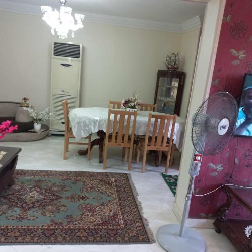 a living room with a table and chairs and a fan at Aqua Tanta Group طنطا Families Only in Tanta