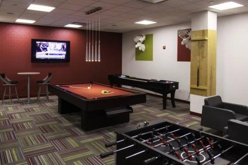 a room with a pool table and a piano at Fantastic 2 BR Apt + Den @Crystal City With Gym in Arlington