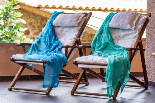 two rocking chairs are covered in blue sheets at Malsova Studio in Kotrónion