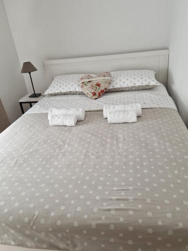 a white bed with two pillows on top of it at Apartment Rose in Sesvete