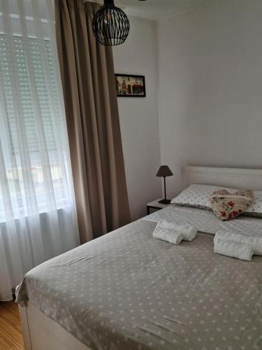 a bedroom with two beds and a window at Apartment Rose in Sesvete