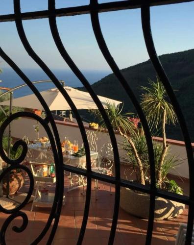 a view of a balcony with palm trees and the ocean at Contrada Cafaro in Salerno