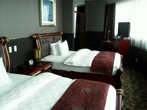 Giường trong phòng chung tại King Ambassador Hotel Kumagaya
