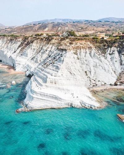 an aerial view of a white cliff over the ocean at ZAHRA ARAGONA in Aragona