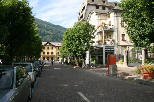 a city street with cars parked on the side of the road at Eco Rooms&Breakfast Tirano in Tirano