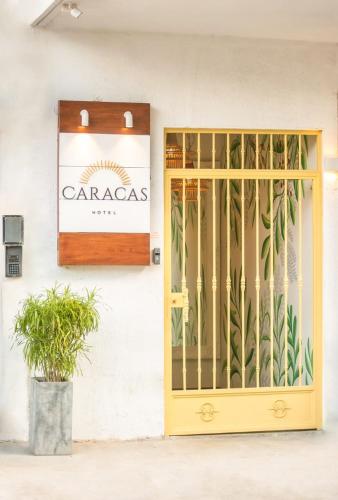 a door to a building with a sign on it at Hotel Caracas in Panama City
