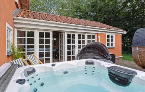 a jacuzzi tub in front of a house at Amazing Home In Græsted With Jacuzzi in Græsted