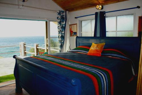 a bedroom with a bed with a view of the ocean at Villas El Bucanero in San Felipe de Puerto Plata