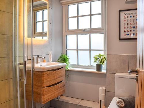 łazienka z umywalką i oknem w obiekcie Yorkshire Cottage w mieście Clayton West