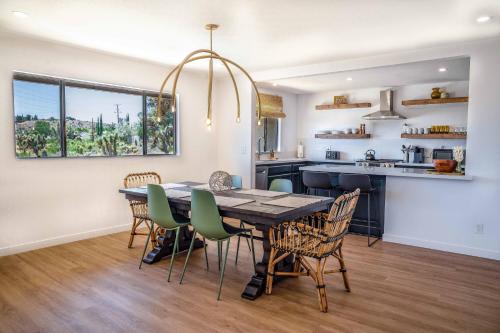 a kitchen and dining room with a table and chairs at Mojave Desert Pied-à-terre in Yucca Valley