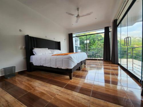a bedroom with a bed and a large window at Eco Hotel Villa Suites in Quillabamba