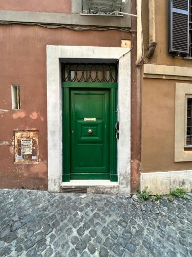 a green door on the side of a building at Glory house Navona Square in Rome