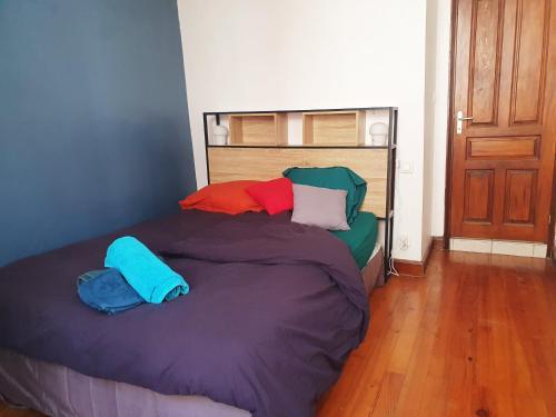 a bed with two pillows on it in a room at La ruelle des 2 vallées in Arreau