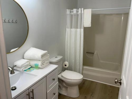 a white bathroom with a toilet and a shower at 2nd Floor, 2 Bedroom Condo, Sleeps 6 in Lake City