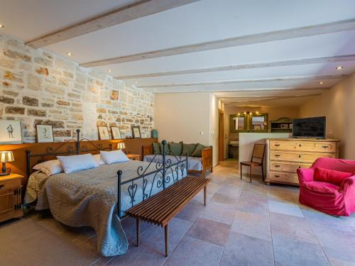 a bedroom with a bed and a living room at Villa Benka, Istrian stone house in Tinjan