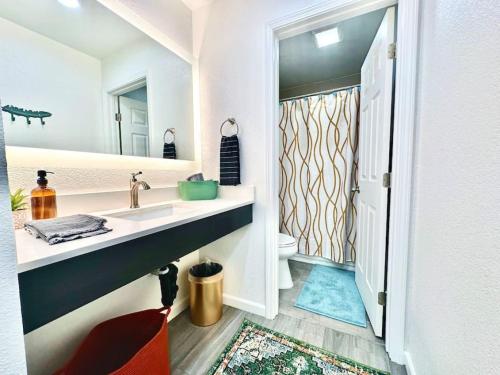 a bathroom with a sink and a mirror at First floor gated, central and remodeled apartment in Sacramento