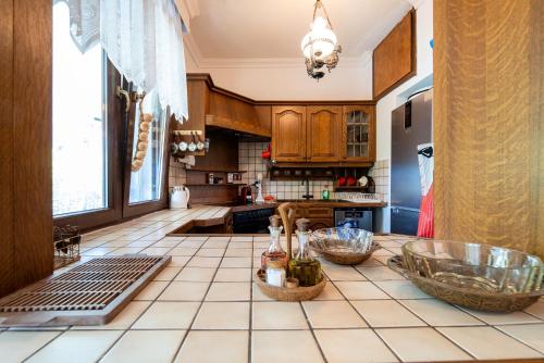 a kitchen with a counter with bottles on it at Villa Sofia Nea Peramos in Néa Péramos