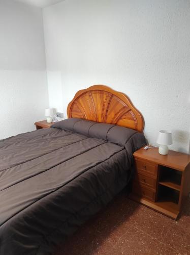 1 dormitorio con 1 cama grande y 2 mesitas de noche en Apartamentos Can Bruguera 4, en Mataró