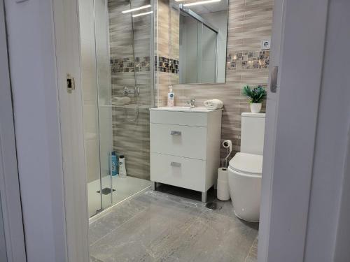 a bathroom with a shower and a sink and a toilet at Dreams Carthago in Cartagena