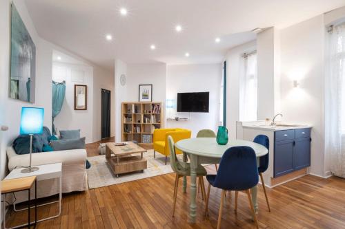 a living room with a table and a couch at Elephant of Gambetta in Metz