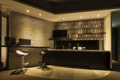 a library with a desk and a chair and books at Queens Hotel II in Taipei