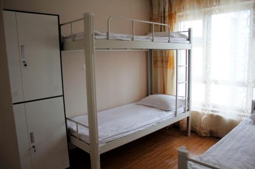 a bedroom with two bunk beds and a window at Tsatsa in Ulaanbaatar
