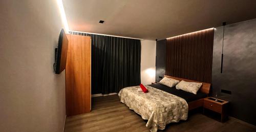 a bedroom with a bed with a red vase on it at Partners Perfect Place in Brela