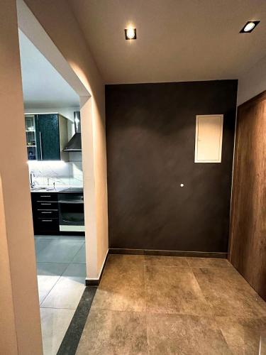 a kitchen with a black wall and a counter top at Partners Perfect Place in Brela