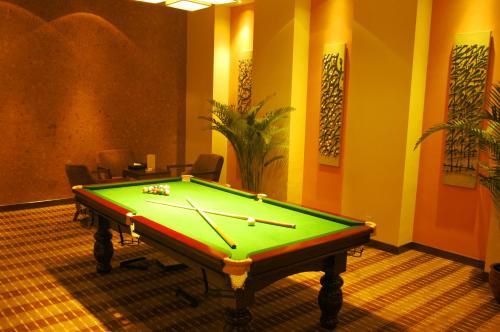 a room with a pool table in a room with ahibition at Dongguan Richwood Garden Hotel in Dongguan