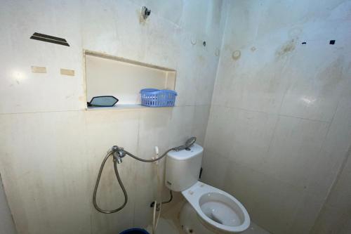 a bathroom with a toilet and a shower in it at OYO 92741 Octav Homestay in Nagoya