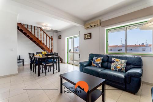 a living room with a couch and a table at #167 Santa Eulália by Home Holidays in Branqueira