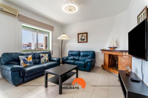 a living room with a couch and a fireplace at #167 Santa Eulália by Home Holidays in Branqueira