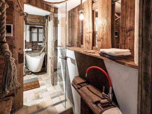 a bathroom with a sink and a bath tub at Altholz-Apartment in Ramsau