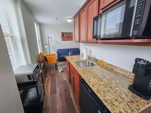a kitchen with a sink and a counter top at Gorgeous and Spacious Studio at the Historic Inman - 200 in Champaign