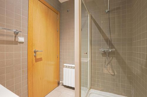 a shower with a glass door in a bathroom at Alcam Gold in Barcelona