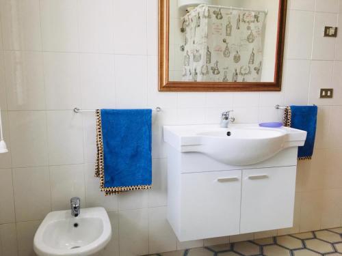 a white bathroom with a sink and a toilet at Villa Ida in Capo Rizzuto