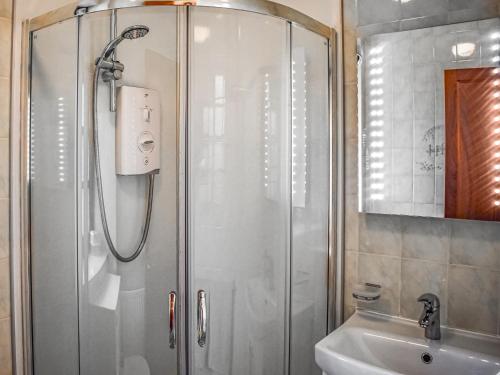 a bathroom with a shower and a sink at Peters in Tarskavaig